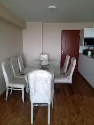 a dining room with a table and white chairs at Habitación Cama 2 plazas persona sola p pareja in Lima