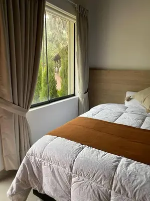 a bedroom with a bed and a large window at FUNDO VIERA: Amplio y acogedor in Lima