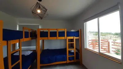 two bunk beds in a room with a window at CASA DE PLAYA Durante todo el año in Punta Negra