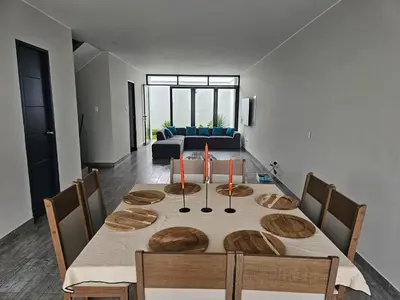 a dining room table with wooden plates on it at Casa en Asia con piscina in Asia