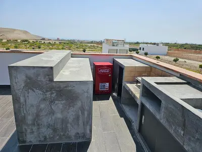 a red coke machine sitting on top of a roof at Casa en Asia con piscina in Asia