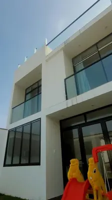 a white building with two hello kitty items in front of it at Casa en Asia con piscina in Asia