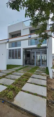 a white building with a pathway in front of it at Casa en Asia con piscina in Asia