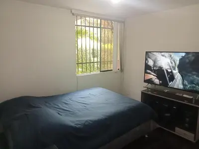 a bedroom with a bed and a flat screen tv at Acogedora Habitacion Independiente in Lima