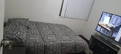 a bedroom with a bed and a flat screen tv at Acogedora Habitacion Independiente in Lima