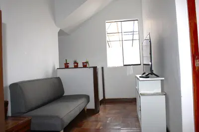 a living room with a couch and a window at Inti Wasi II in Cusco