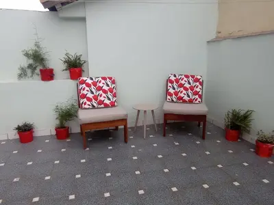two chairs and a table in a room with plants at Inti Wasi II in Cusco
