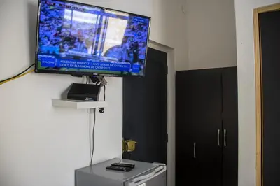 a flat screen tv hanging on a wall in a room at Plaza Mayor Lima in Lima