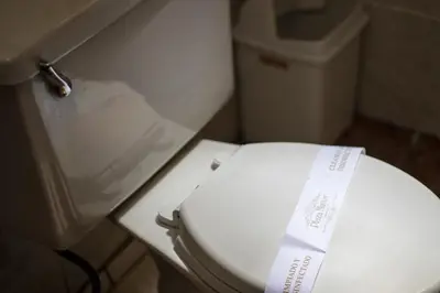 a bathroom with a white toilet with a box on it at Plaza Mayor Lima in Lima