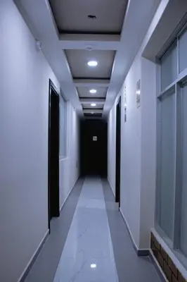 a corridor in an office building with a black door at PRANA in Huancayo