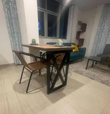 a wooden table and a chair in a living room at Huancayo Suite 4-Cómodo MiniDpto 2 camas in Huancayo