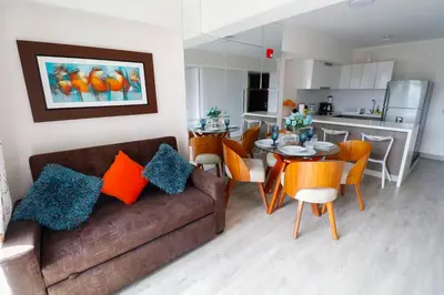 a living room with a couch and a table with chairs at Beautiful floor 9th apartment Pool Gym Barranco in Lima