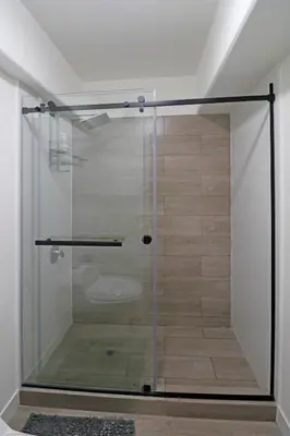 a glass shower door in a room with a bathroom at Beautiful floor 9th apartment Pool Gym Barranco in Lima