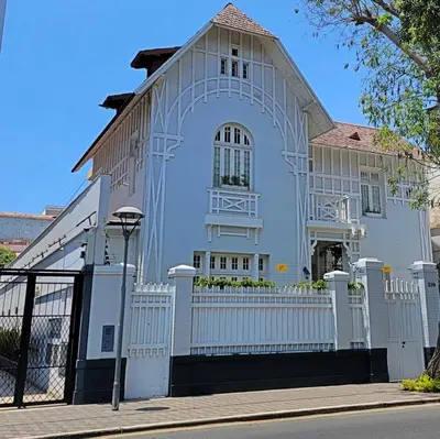a white house with a white fence at Casa Cáceres in Lima