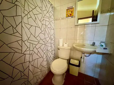 a bathroom with a white toilet and a sink at La Casa de Isidora in Pan de Azúcar
