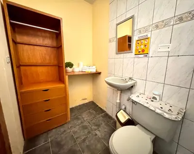 a bathroom with a toilet and a sink at La Casa de Isidora in Pan de Azúcar