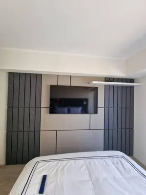 a bedroom with a bed and a tv on the wall at Barranco Aparment Luxury in Lima