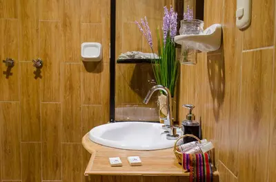 a bathroom with a sink and a vase of flowers at Cusco Bed and Breakfast in Cusco