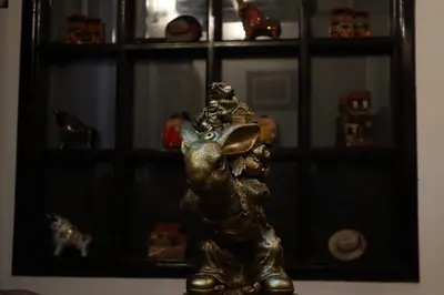 a gold elephant statue sitting in front of a shelf at Cusco Bed and Breakfast in Cusco