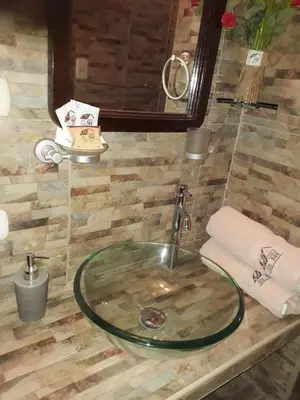 a sink in a bathroom with a mirror at Cusco Bed and Breakfast in Cusco