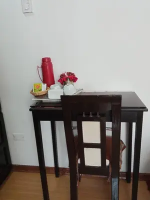 a black table and chair with a plate and a pitcher at Cusco Bed and Breakfast in Cusco
