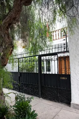 a black gate in front of a white building at Departamento Loft en Olivar de San Isidro in Lima