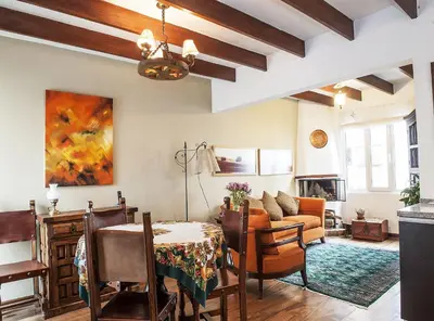 a living room with a table and chairs and a couch at Departamento Loft en Olivar de San Isidro in Lima
