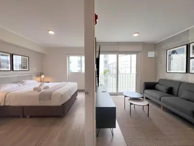a bedroom with a bed and a couch at Peruvian Apartments Miraflores in Lima