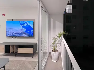 a living room with a tv on a wall at Peruvian Apartments Miraflores in Lima