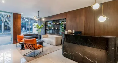 a living room with a couch and a table and chairs at Peruvian Apartments Miraflores in Lima