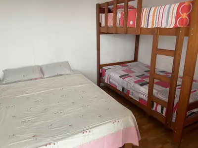 a bedroom with two bunk beds and a bed at Villa Alfonso - Casa playa con piscina temperada in Lima