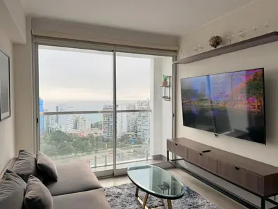 a living room with a large flat screen tv at Peruvian Apartments Barranco 2004 in Lima