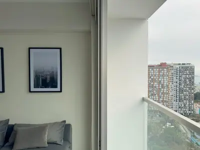 a living room with a couch and a window at Peruvian Apartments Barranco 2004 in Lima