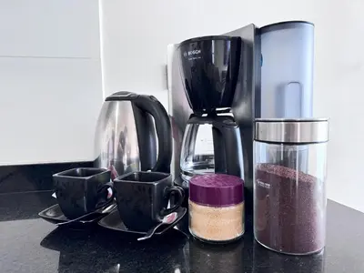 a counter top with a coffee maker and two cups at Peruvian Apartments Barranco 2004 in Lima