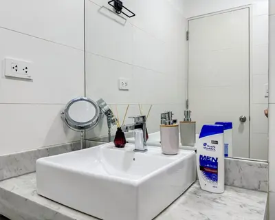 a bathroom with a white sink and a mirror at Peruvian Apartments Barranco 1606 in Lima
