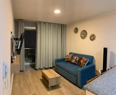 a living room with a blue couch and a table at Mousse PL in Lima