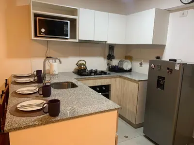 a kitchen with a sink and a refrigerator at Mousse PL in Lima