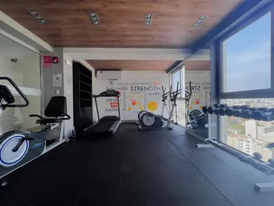 a gym with several treadmills and bikes in a room at Peruvian Apartments Barranco 1609 in Lima