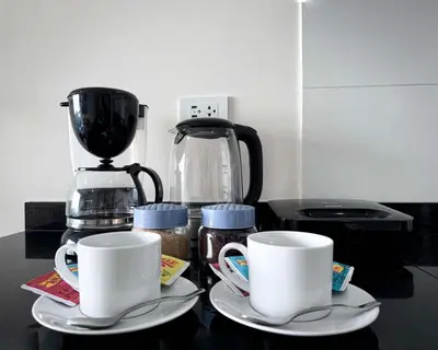 a counter with two coffee cups and a blender at Peruvian Apartments Barranco 1806 in Lima