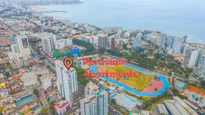 an aerial view of a city with buildings and the ocean at Peruvian Apartments Barranco 904 in Lima