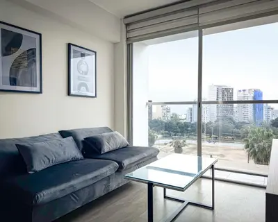 a living room with a couch and a glass table at Peruvian Apartments Barranco 904 in Lima