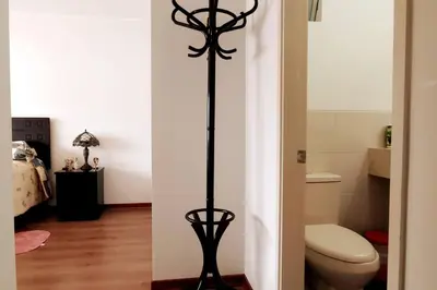 a bathroom with a toilet and a black pole at Excellent apartment, access to pool, grills, ballroom in Lima
