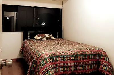 a bedroom with a bed with a blanket on it at Excellent apartment, access to pool, grills, ballroom in Lima