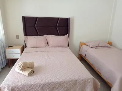 a bedroom with two beds with towels on them at Hotel Sunlight in Paracas