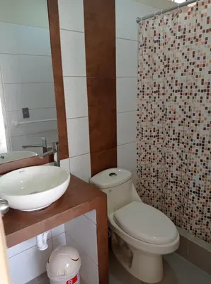 a bathroom with a toilet and a sink and a shower at Hotel Sunlight in Paracas