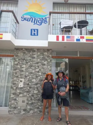 two people standing in front of a building at Hotel Sunlight in Paracas