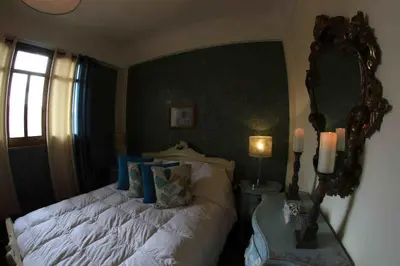 a bedroom with a bed with a large mirror at Bamba House Cusco in Cusco