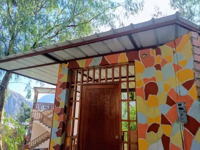 a house with awning over the door at Hotel El Gran Valletero in Cotahuasi