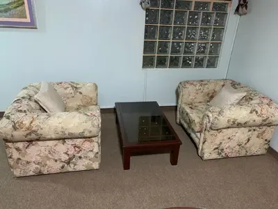 two chairs and a coffee table in a living room at Grand Hotel Betsy in Lima