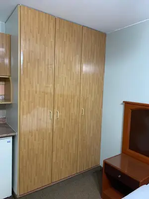 a large wooden cabinet in a room with a tv at Grand Hotel Betsy in Lima